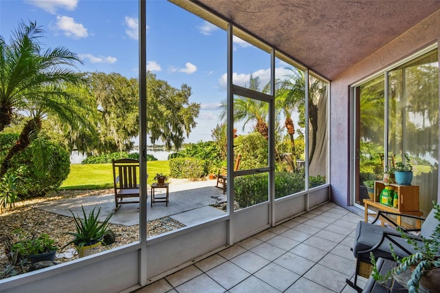 unfurnished sunroom featuring a water view