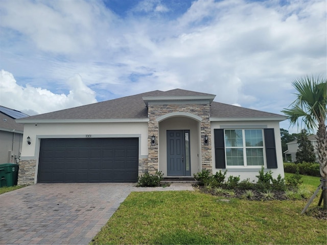 view of front facade with a garage and a front lawn