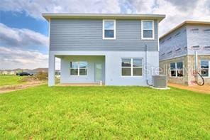 rear view of property featuring a yard