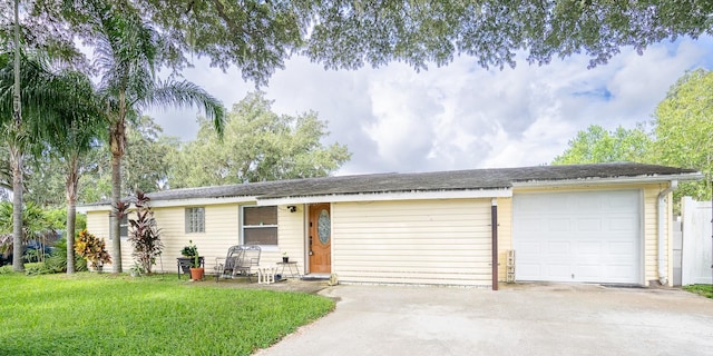 ranch-style house with a garage and a front yard