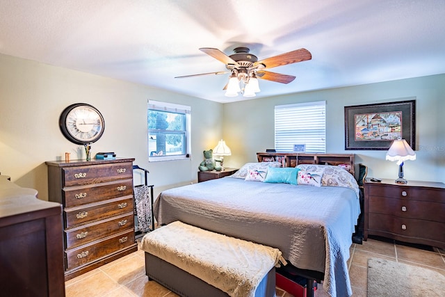 bedroom with ceiling fan and light tile patterned floors