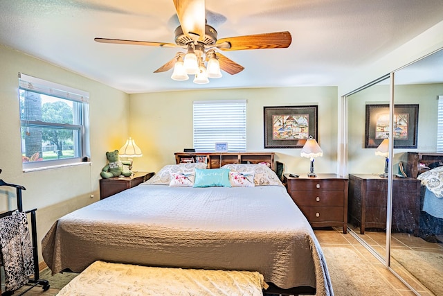 bedroom featuring ceiling fan and a closet