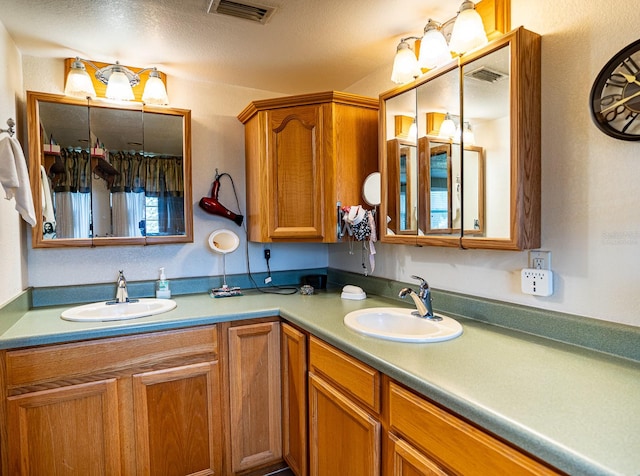 bathroom with vanity and a textured ceiling