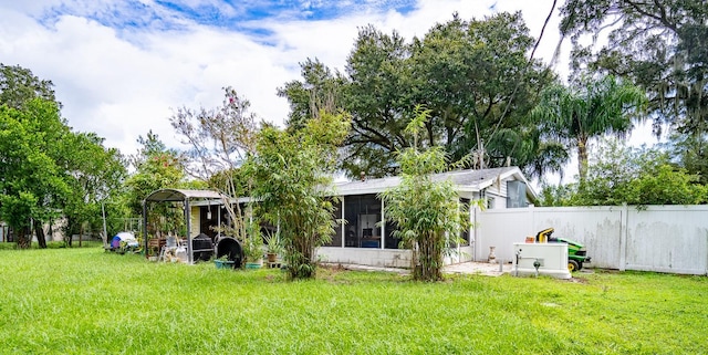 view of yard with a sunroom