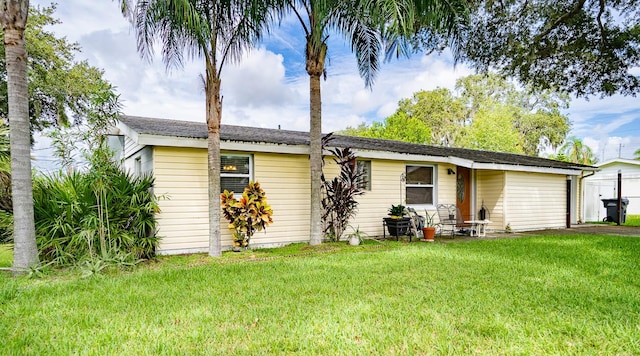 rear view of house featuring a yard and a patio