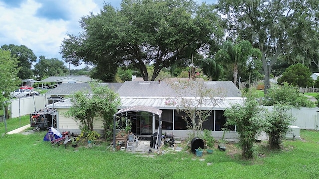 back of house with a lawn