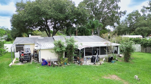 rear view of property with a yard