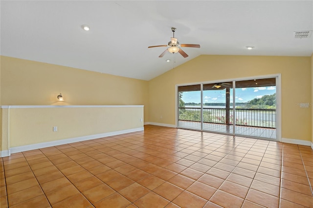 tiled empty room with lofted ceiling and ceiling fan