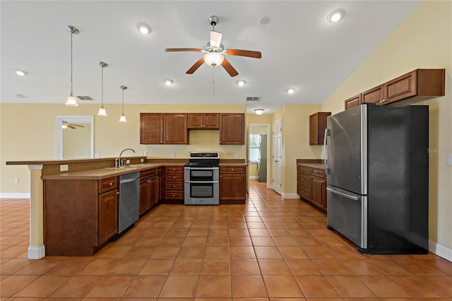 kitchen with pendant lighting, ceiling fan, appliances with stainless steel finishes, and vaulted ceiling