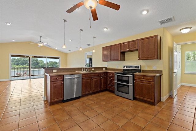 kitchen with light tile patterned floors, appliances with stainless steel finishes, lofted ceiling, ceiling fan, and pendant lighting