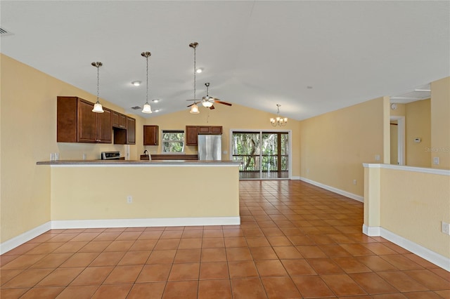 kitchen featuring light tile patterned floors, vaulted ceiling, ceiling fan with notable chandelier, appliances with stainless steel finishes, and sink