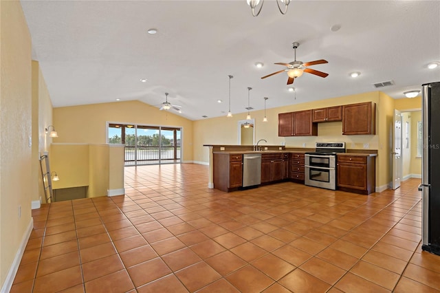 kitchen featuring pendant lighting, vaulted ceiling, sink, ceiling fan, and appliances with stainless steel finishes