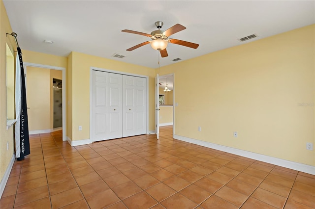 unfurnished bedroom with light tile patterned floors, ceiling fan, and a closet