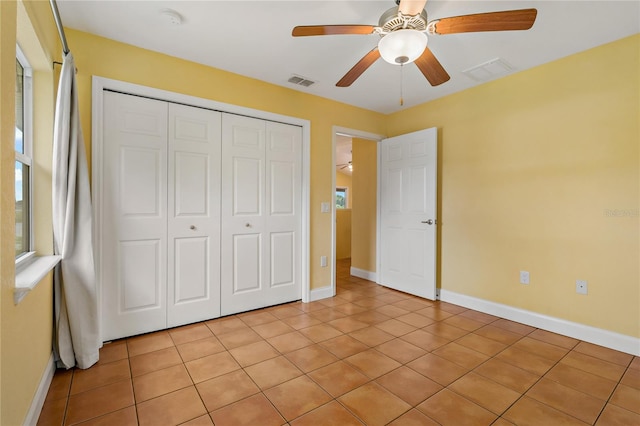 unfurnished bedroom featuring a closet, ceiling fan, and light tile patterned flooring