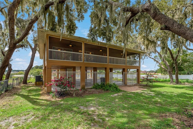 rear view of house featuring a lawn, ceiling fan, a patio, and central AC