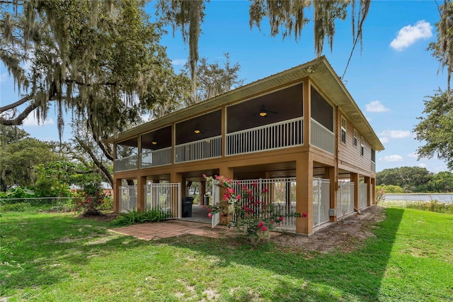 rear view of property featuring a yard and a patio