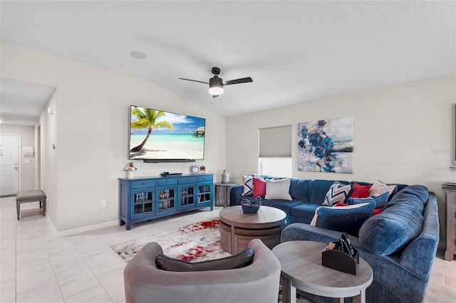 tiled living room featuring lofted ceiling, ceiling fan, and a textured ceiling