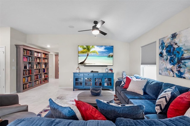 living room with lofted ceiling, ceiling fan, and light tile patterned floors