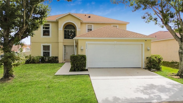 view of front of property with a garage and a front lawn