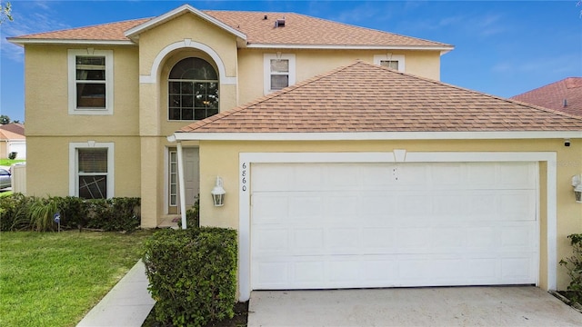 view of front of property featuring a garage and a front lawn