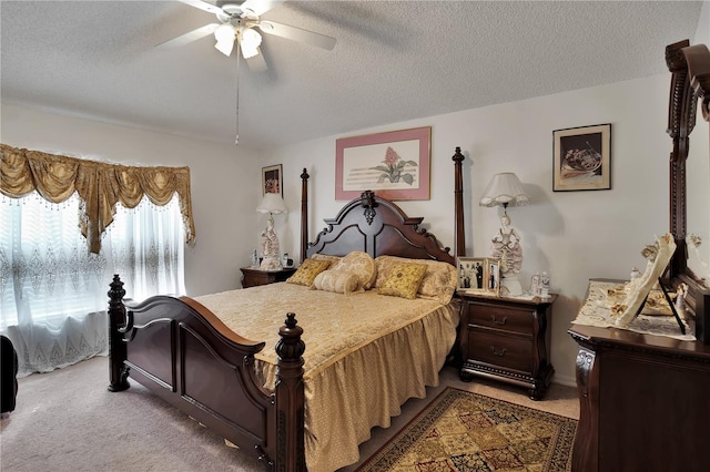 carpeted bedroom with a textured ceiling and ceiling fan