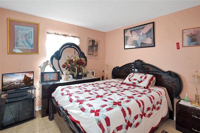 tiled bedroom featuring a textured ceiling