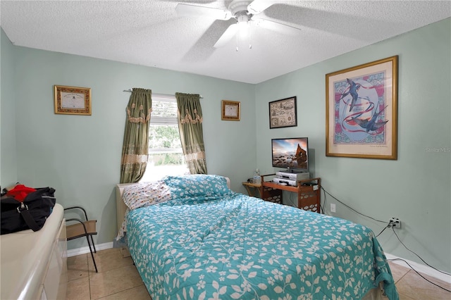 tiled bedroom featuring a textured ceiling and ceiling fan