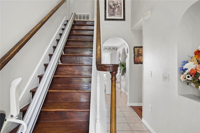 stairway with tile patterned floors