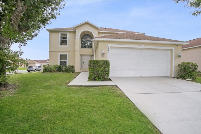 view of front of home with a garage and a front lawn