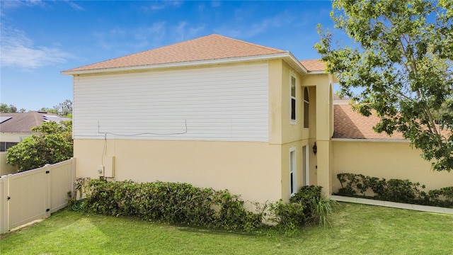 view of property exterior with a yard