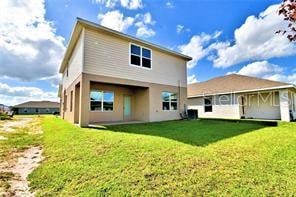 back of property featuring a lawn