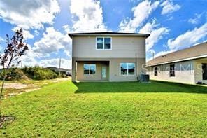 rear view of house featuring a lawn