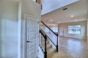 stairs featuring tile patterned floors