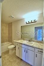 bathroom featuring tile patterned flooring, vanity, and toilet