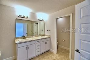 bathroom featuring toilet and vanity