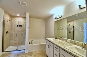 bathroom featuring tile patterned flooring, separate shower and tub, and vanity