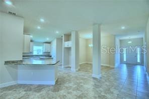 kitchen with kitchen peninsula and white cabinets