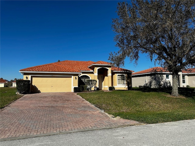 mediterranean / spanish home featuring a garage and a front yard