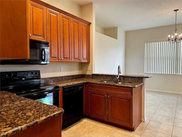 kitchen with dark stone counters, black appliances, kitchen peninsula, an inviting chandelier, and sink