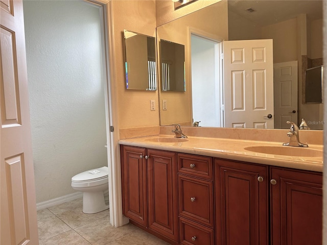 bathroom with vanity, toilet, and tile patterned flooring