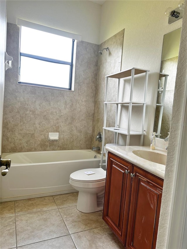 full bathroom with tile patterned flooring, vanity, toilet, and tiled shower / bath