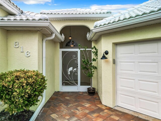 doorway to property with a garage