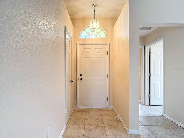 doorway to outside with light tile patterned floors