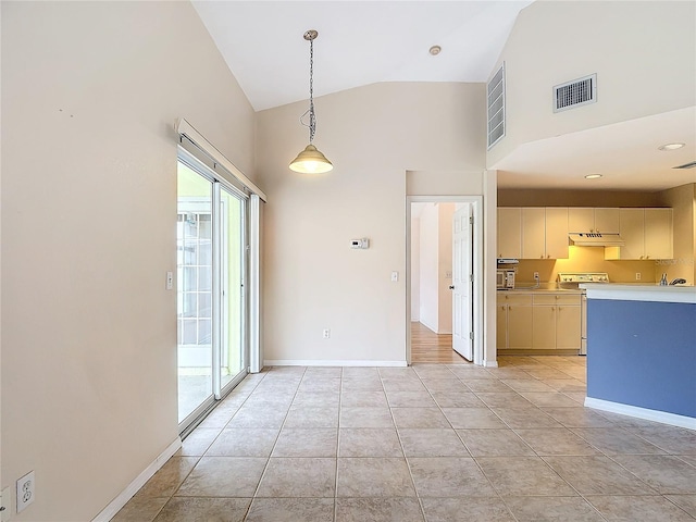 interior space featuring sink, light tile patterned floors, and high vaulted ceiling