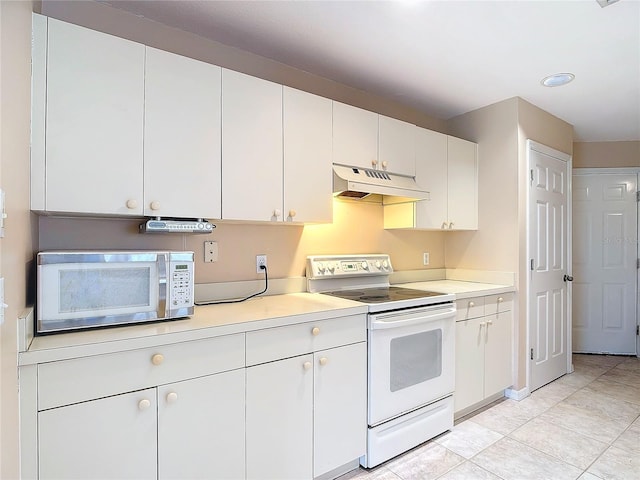 kitchen featuring white electric range oven, light tile patterned floors, and white cabinetry