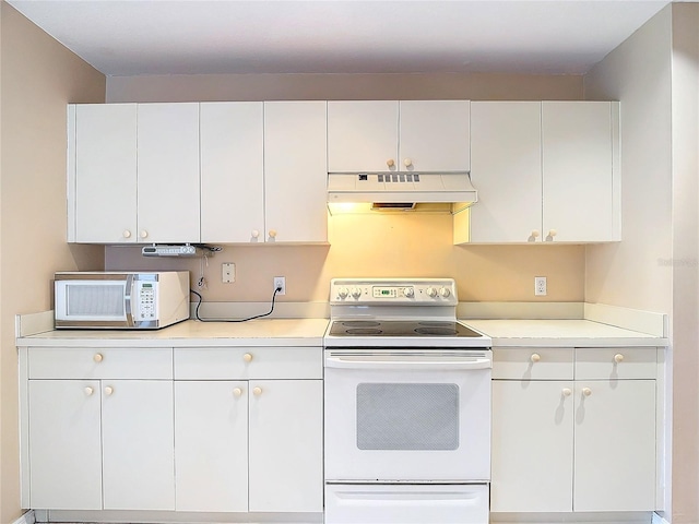 kitchen with white appliances and white cabinetry