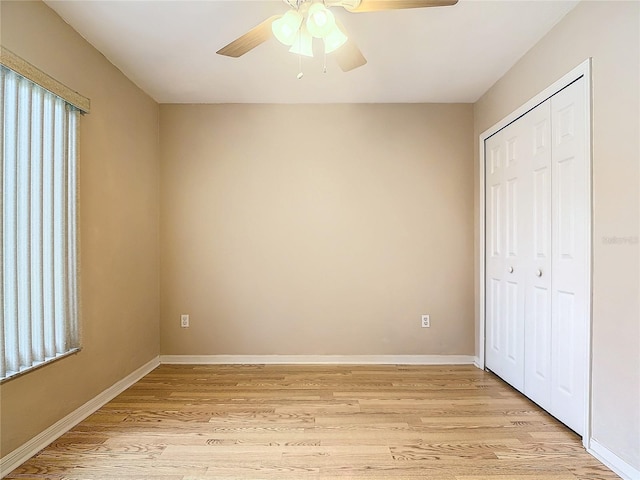 unfurnished bedroom with a closet, light wood-type flooring, and ceiling fan