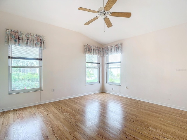 unfurnished room featuring light hardwood / wood-style flooring, a wealth of natural light, lofted ceiling, and ceiling fan