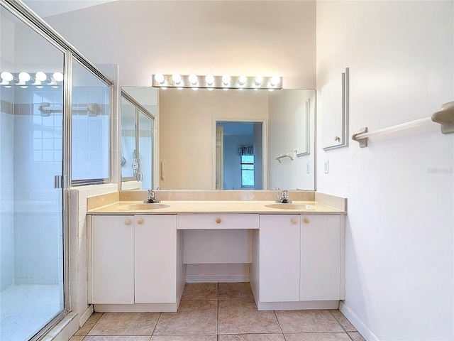 bathroom with walk in shower, vanity, and tile patterned flooring