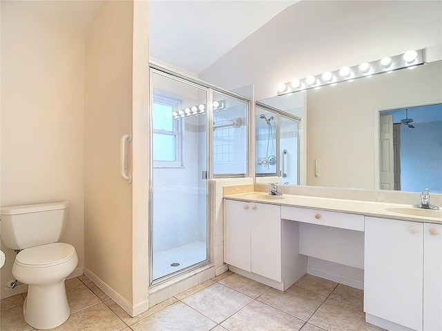 bathroom featuring vanity, toilet, ceiling fan, and a shower with door